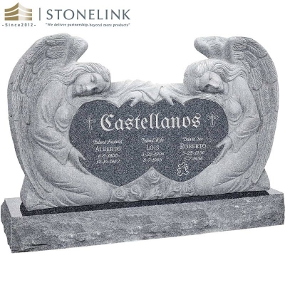 Kneeling angels embracing double heart granite headstone